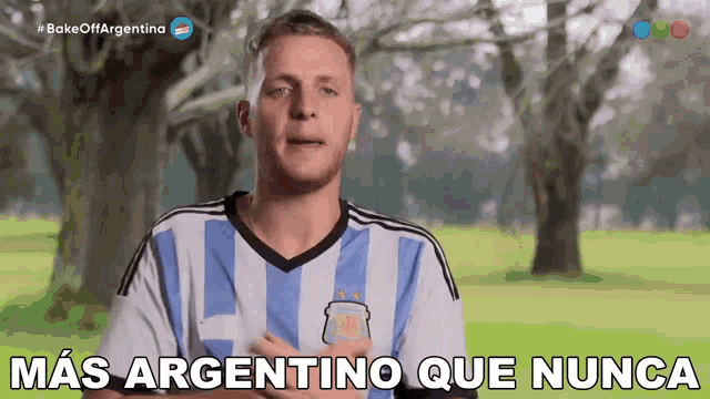 a man wearing a argentina shirt says " mas argentino que nunca "
