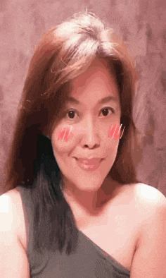 a close up of a woman 's face with a slight smile on her face .