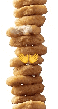 a stack of chicken nuggets with a smiley face on top of them
