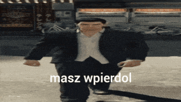 a man in a suit and hat is walking down a sidewalk with the words masz wpierdol written on the bottom