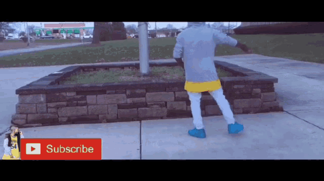 a person is standing on a sidewalk with a subscribe button on the bottom