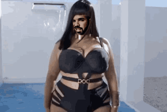 a woman in a black bikini with a man 's face on her face .
