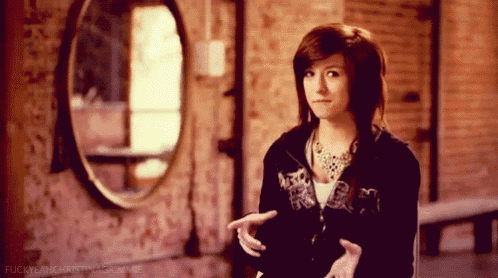 a girl standing in front of a mirror with the words fuckyeahkristina.com written on the bottom