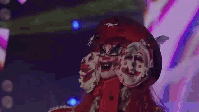 a person in a costume is standing on a stage in front of a swirl .