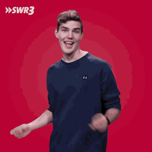 a man wearing a blue under armour shirt stands in front of a red background with swr3 written on it