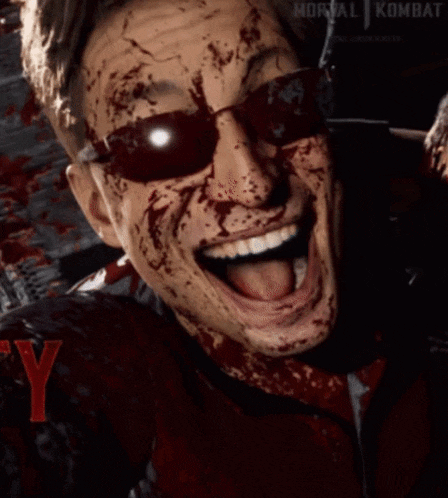 a man with blood on his face is wearing sunglasses and a jacket that says mortal kombat