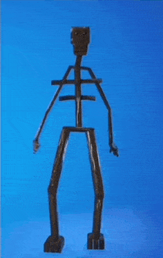 a skeleton made out of wood is standing on a blue surface .