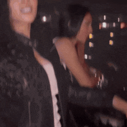 two women are standing next to each other with one wearing a black jacket