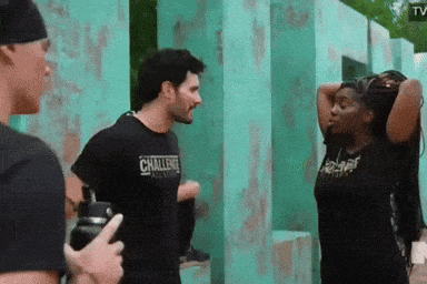a man wearing a challenge t-shirt stands next to a woman