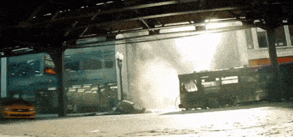 a yellow taxi is driving underneath a train with a sign that says subway