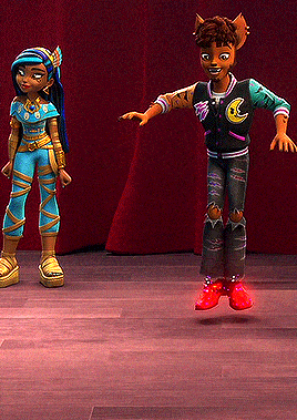 two monster high characters are standing next to each other