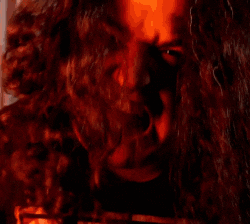 a close up of a man 's face with a red background