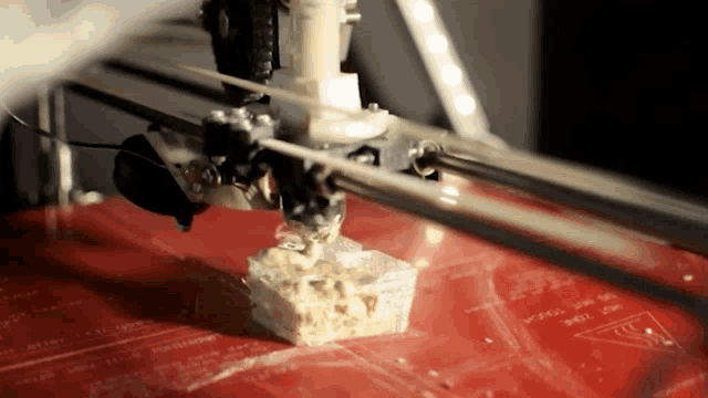 a 3d printer is printing a small piece of plastic