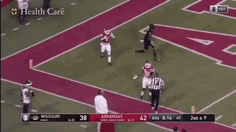 a football game is being played between missouri and arkansas and the score is 38 to 42 .