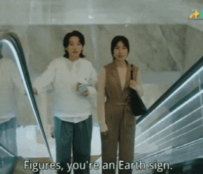two women on an escalator with the words figures you 're an earth sign behind them