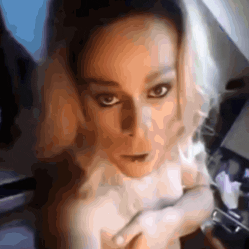 a close up of a woman 's face with a blurred image
