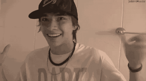 a young man wearing a hat and a shirt that says daddy on it