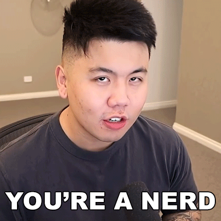a man with a tattoo on his arm is wearing a t-shirt that says you 're a nerd
