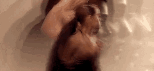 a blurry picture of a woman 's face and body in a bathtub
