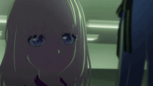 a girl with blonde hair and blue eyes is looking at the camera