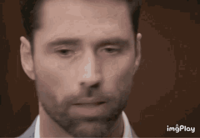 a close up of a man 's face with the words imgplay in the lower right corner