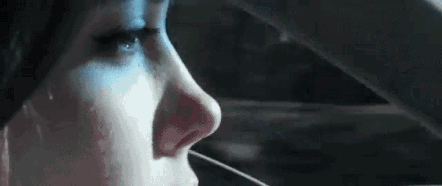 a close up of a woman 's face in a car with her eyes closed .