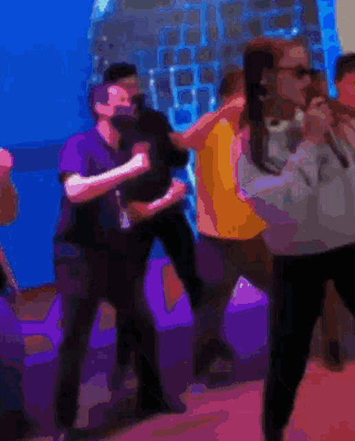 a blurry picture of people dancing in a club