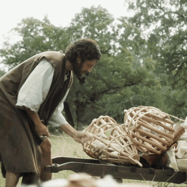 a man is pushing a cart full of baskets