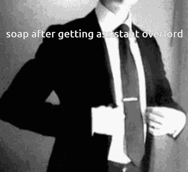 a man in a suit and tie is standing in front of a wall .