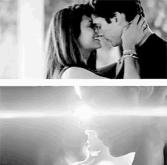 a black and white photo of a man and woman kissing each other .