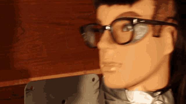 a close up of a mannequin 's face wearing glasses