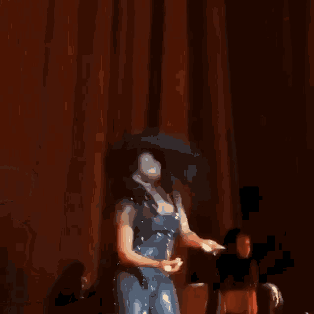 a woman in a blue bodysuit is dancing on a stage