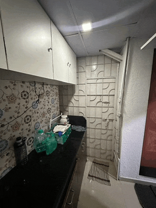 a kitchen with white cabinets and a black counter