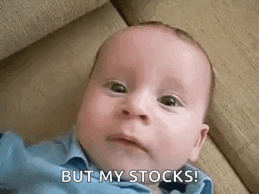 a baby is laying on a couch and making a funny face while saying `` but my stocks '' .