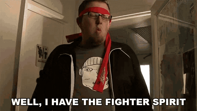a man wearing glasses and a headband says well i have the fighter spirit