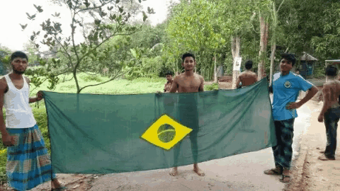 a group of men holding a large green flag with a yellow circle in the center