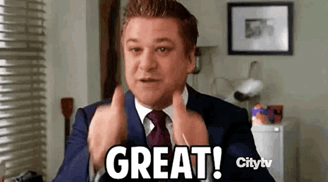 a man in a suit and tie is giving a thumbs up and saying `` great ! ''