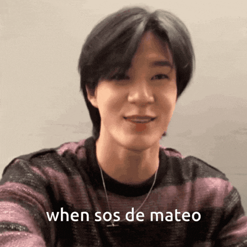 a young man wearing a purple and black striped sweater is smiling and says when sos de mateo