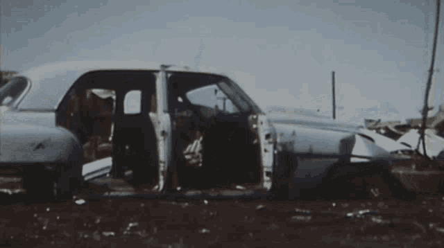 a crane is lifting a car that has crashed