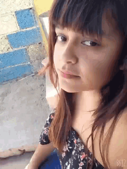 a close up of a girl 's face with the number b612 on the bottom right corner