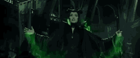 maleficent from maleficent is surrounded by green lightning and smoke .