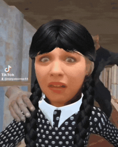 a girl with braids and a polka dot shirt is making a funny face in a tik tok video