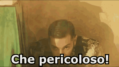 a man is standing in a room with the words che pericoloso written on the bottom