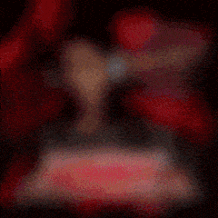 a blurred image of a woman wearing headphones and a red background