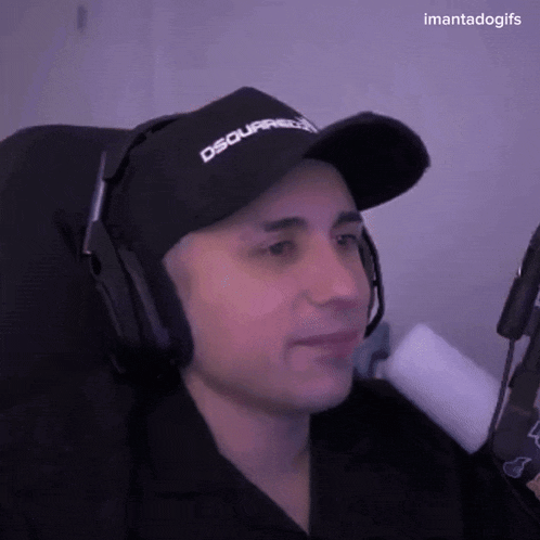 a man wearing headphones and a hat that says dsquared2 on it