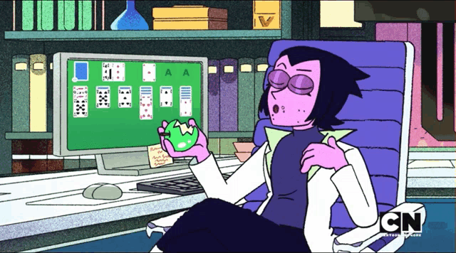 a cartoon character from cn sits in front of a computer screen playing solitaire
