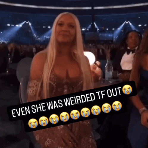 a woman sitting in a crowd with a caption that says even she was weirded tf out