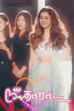 a woman in a white dress is smiling in front of a sign that says ' thalapathynayansharafan '
