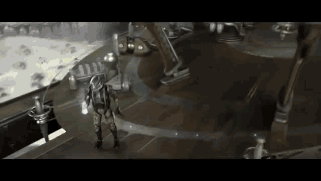 a man in a space suit is standing in a room with a robot .