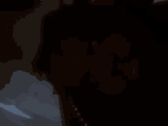 a blurry image of a person 's face in the dark